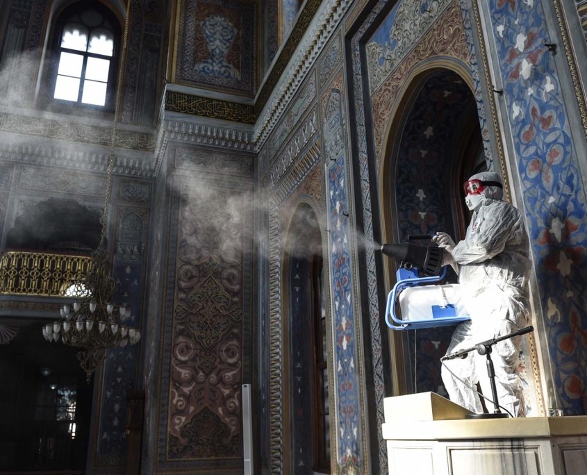 A member of Istanbul's Municipality disinfects the mosque
