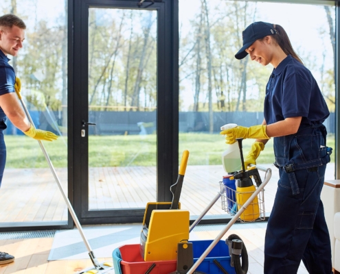 Janitors mopping floor of commercial building entrance