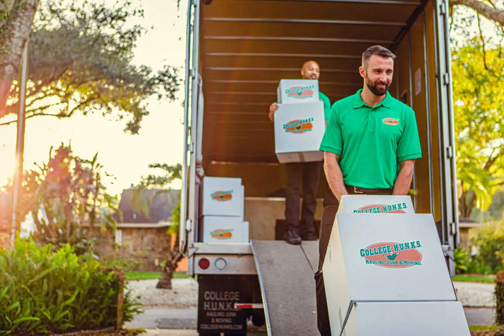 image of employees at College Hunks moving away boxes into a moving truck